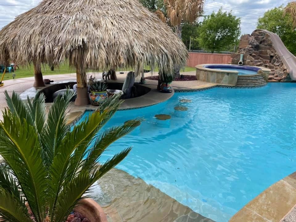 Freeform swimming pool with shaded palapa