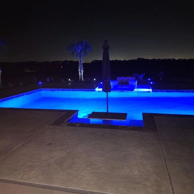 Modern geometric pool illuminated at night